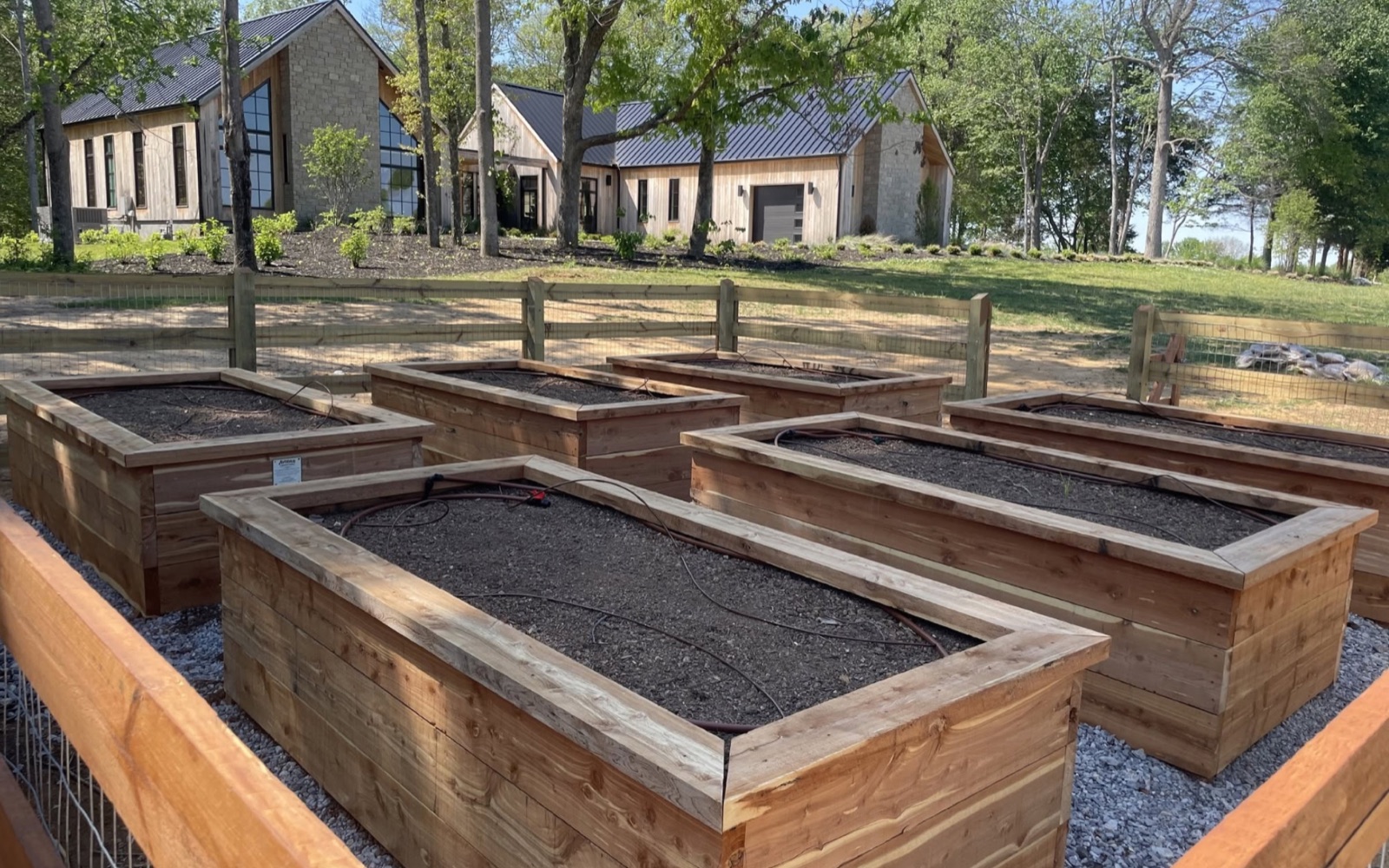 Avodah cedar raised beds with irrigation in a fenced estate kitchen garden