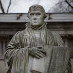 Close-up of the Martin Luther statue holding a book in Berlin, Germany.